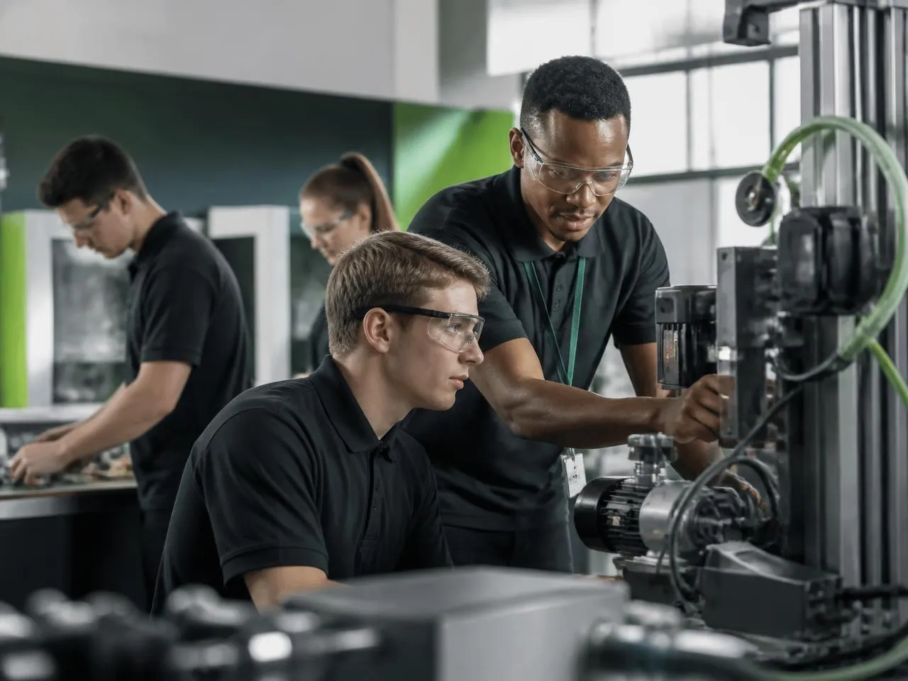 Students working with an instructor in a vocational training lab