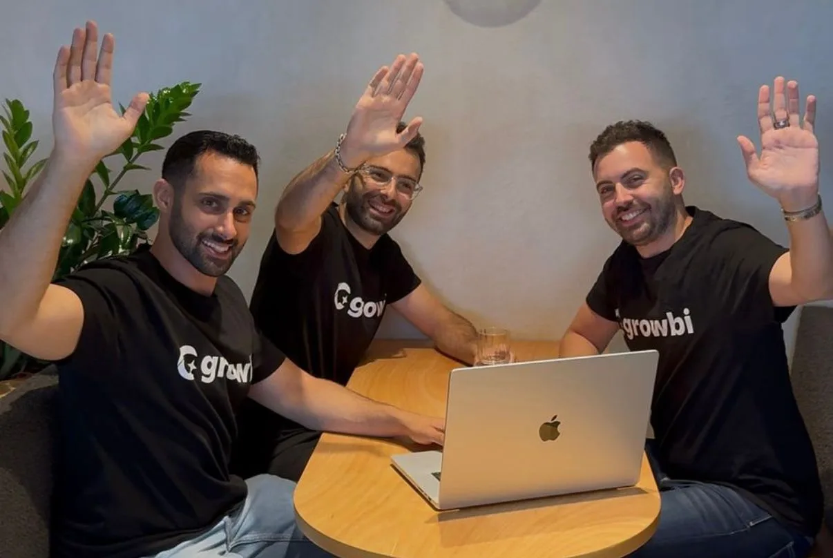 Growbi team waving from the office